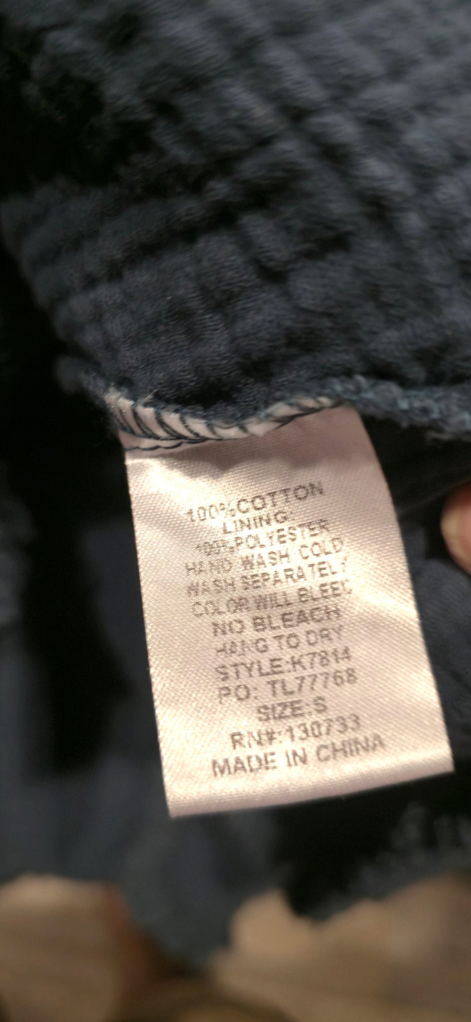 Care label inside the Umgee navy embroidered dress showing 100 percent cotton lining
